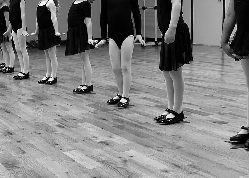 A Group of Childs in Black Leotards and Black Shoes