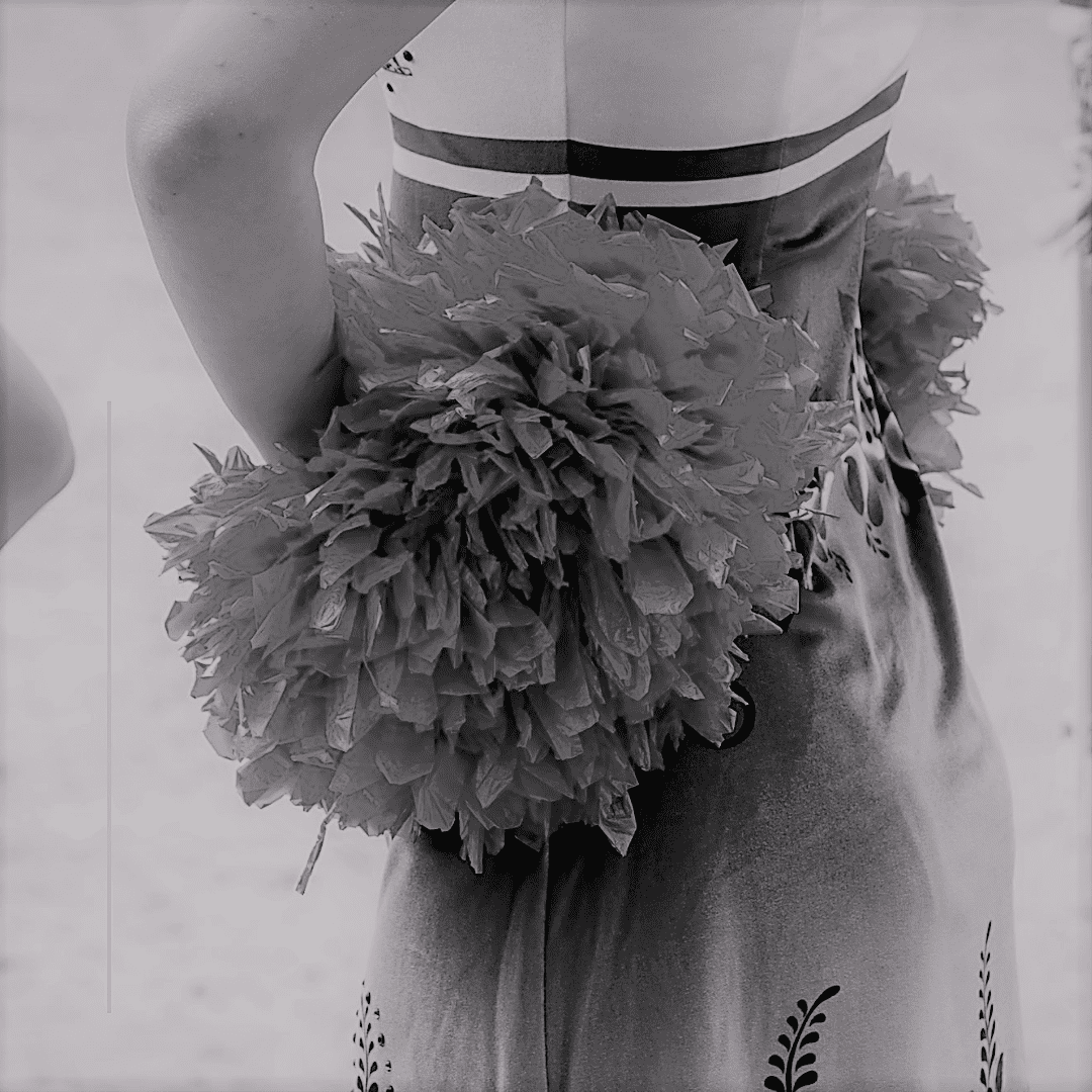 A Person Wearing a Dress With POM Poms