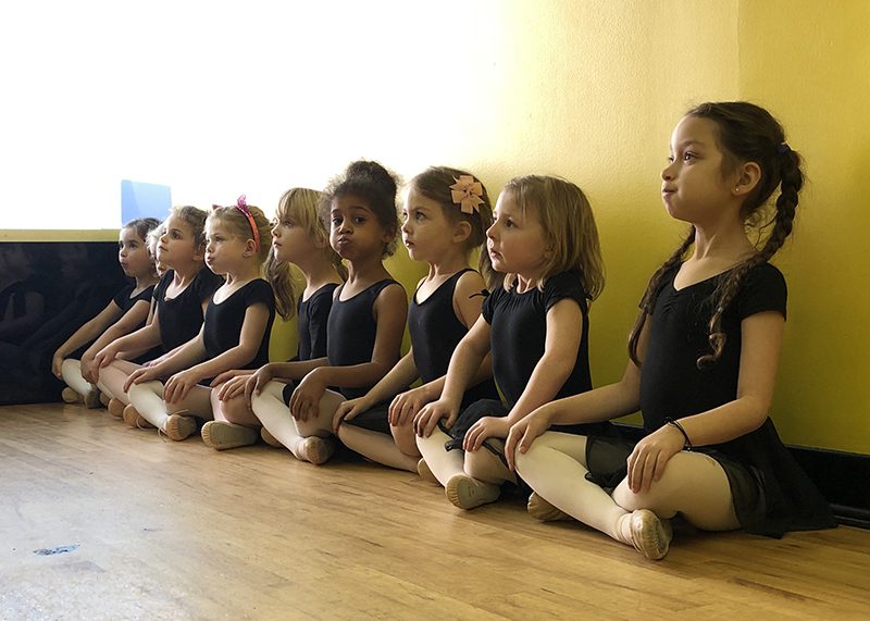 A Group of Childs Sitting on the Floor